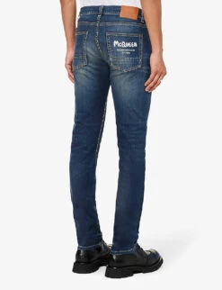Alexander McQueen Graffiti Brand-embroidered Tapered-leg Regular-fit Stretch-denim Jeans -AllSain Clothing Shop R04153535 BLUEWASHED ALT03