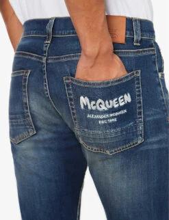 Alexander McQueen Graffiti Brand-embroidered Tapered-leg Regular-fit Stretch-denim Jeans -AllSain Clothing Shop R04153535 BLUEWASHED ALT04